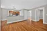 Bright and inviting open-plan kitchen and living area with hardwood floors and modern lighting, ideal for contemporary living.