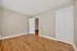 Bright room with elegant wooden flooring and classic white doors, offering a spacious interior and inviting atmosphere.