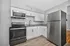 Modern kitchen with stainless steel appliances, sleek granite countertops, and stylish white cabinetry. A perfect blend of functionality and elegance.