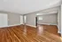 Bright and spacious open-concept living area with warm wooden flooring and ample natural light.