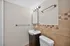 Chic bathroom featuring elegant tile work, modern fixtures, and stylish lighting.