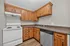 Charming kitchen with rustic wooden cabinets, modern appliances, and sleek countertops, perfect for culinary creativity.