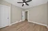 Inviting room with modern ceiling fan, elegant wood flooring, and neutral wall tones, perfect for a cozy bedroom or home office.