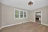 Bright, open living space with large windows and modern kitchen featuring stainless steel appliances.