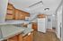 Charming kitchen with wooden cabinetry, modern appliances, and a cozy corner layout perfect for culinary creativity.