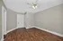 Bright room with elegant wood flooring, neutral walls, and a ceiling fan, ideal for a cozy living space.