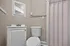 Charming bathroom featuring elegant fixtures, a sleek vanity, and a cozy ambiance.