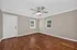 Inviting room with elegant hardwood floors, neutral walls, and abundant natural light, perfect for a cozy living space.