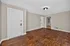 Bright, spacious living area with elegant hardwood floors and modern white doors, ideal for stylish living.
