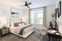 Elegant bedroom with a cozy bed, stylish decor, and abundant natural light, perfect for relaxation and comfort.