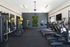Contemporary fitness center featuring state-of-the-art treadmills, exercise bikes, and colorful workout equipment.