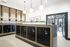 Contemporary mailroom with sleek black lockers and elegant wood paneling, enhanced by modern pendant lighting and artistic wall decor.