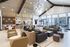 Luxurious modern living space featuring sleek furniture, elegant lighting fixtures, and expansive windows for natural light.