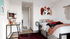 private bedroom with bed, dresser, study desk and chair