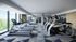 room with  cardio equipment and machines located in fitness center with floor to ceiling windows
