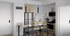 kitchen with stainless steel appliances, ample cabinet space and high-rise dining set