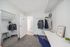 private bedroom with desk and closet rack