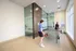 Modern recreation room featuring a ping pong table and large glass windows for natural light.
