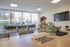 Modern co-working space with large windows, natural light, and a comfortable seating area for productivity.