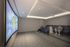 Modern apartment cinema room with comfortable seating and large projection screen.