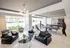 Chic and modern apartment lounge with a stylish chandelier, comfortable seating, and a vibrant game area featuring a ping pong and pool table.