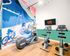 Vibrant fitness area with modern exercise bikes and treadmill, featuring a colorful cycling mural for an inspiring workout environment.