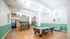 Bright and contemporary recreational room featuring a pool table, cozy seating, and a snack area with vibrant wallpaper and modern lighting.