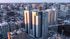 Spectacular aerial view of modern high-rise apartments in a vibrant urban setting, showcasing sleek architecture and urban sophistication.