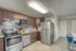 Modern kitchen with sleek cabinets, stainless steel appliances, and chic tile flooring, boasting a contemporary and inviting atmosphere.