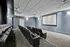 Modern apartment media room featuring plush theater seating and a large projection screen, perfect for entertainment.