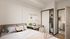 Contemporary bedroom with stylish decor, featuring a cozy workspace, sliding closet doors, and an ensuite bathroom in a modern apartment.