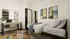 Chic and cozy bedroom with a stylish workspace, modern decor, and ample storage, perfect for a tranquil living experience.