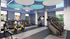 Modern fitness center with state-of-the-art cardio machines, sleek blue decor, and natural light.