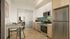 Modern kitchen featuring sleek stainless steel appliances, vibrant backsplash, and a cozy dining nook with elegant fixtures.