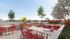 Chic outdoor dining area featuring vibrant red seating, modern grill station, and lush greenery, perfect for entertaining.
