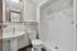 Contemporary bathroom design showcasing a sleek pedestal sink, modern toilet, and spacious shower, perfect for luxury living.