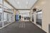 Modern lobby area with sleek elevators, vibrant vending machine, and access to laundry facilities offering convenience and style at Preston House.