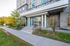 Elegant entrance of Preston House with modern architecture and lush greenery, offering a welcoming and serene living environment.