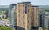 Impressive high-rise residential building with modern architecture, offering stunning views amidst lush greenery.