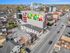 Vibrant urban scene featuring a striking mural on a modern building facade, surrounded by diverse architecture and lively streetscape.