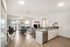 Modern open-plan living area featuring a sleek kitchen, cozy lounge with holiday decor, and abundant natural light.