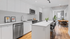 Modern open-plan kitchen with sleek white cabinetry, stainless steel appliances, and a stylish dining area with wooden flooring.