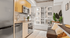 Modern kitchen with sleek appliances and cozy seating area by a large window, offering a bright and inviting atmosphere.