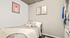 Cozy bedroom with contemporary art, lush bedding, and stylish bookshelf accents.