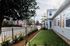 Private turfed yard with lush landscaping.