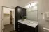 Chic modern bathroom with elegant cabinetry and a spacious walk-in closet, perfect for stylish living.