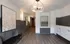 Elegant apartment lobby with modern art, stylish chandelier, and sleek mailboxes creating a welcoming atmosphere.
