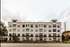 Elegant and modern apartment building with multiple floors, featuring large windows and a clean facade, offering stylish urban living.
