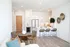 Chic modern apartment featuring an open kitchen with island seating, stylish wicker chairs, and elegant decor.