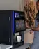 Modern coffee machine with digital interface dispensing a hot beverage into a stylish mug, enhancing the chic kitchen ambiance.